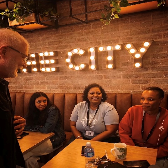 Guests gathered beneath a "The City" sign in the Northplace lounge